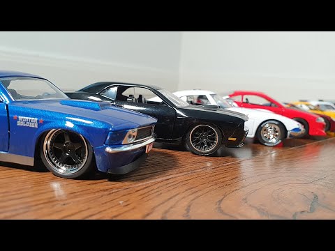 Jada toys diecast cars driving on the fllor and parking next to each other