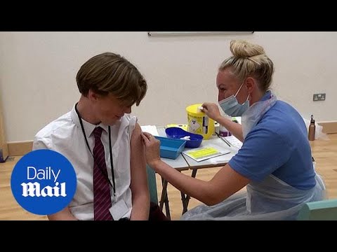 School children receive COVID-19 vaccines at school in England
